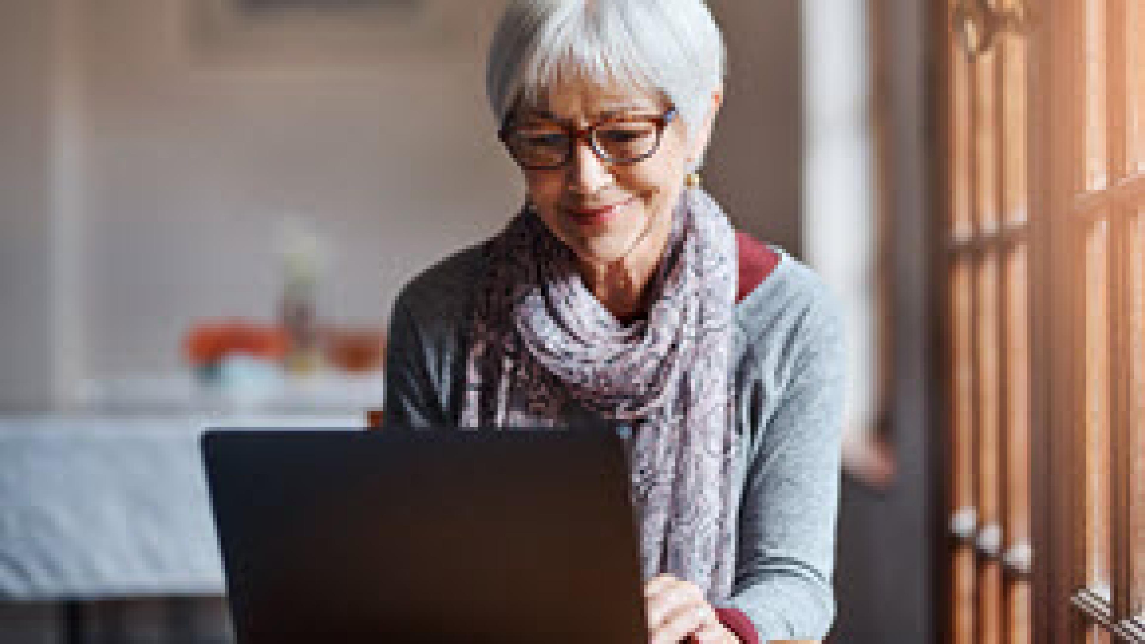 Senior woman looking at laptop