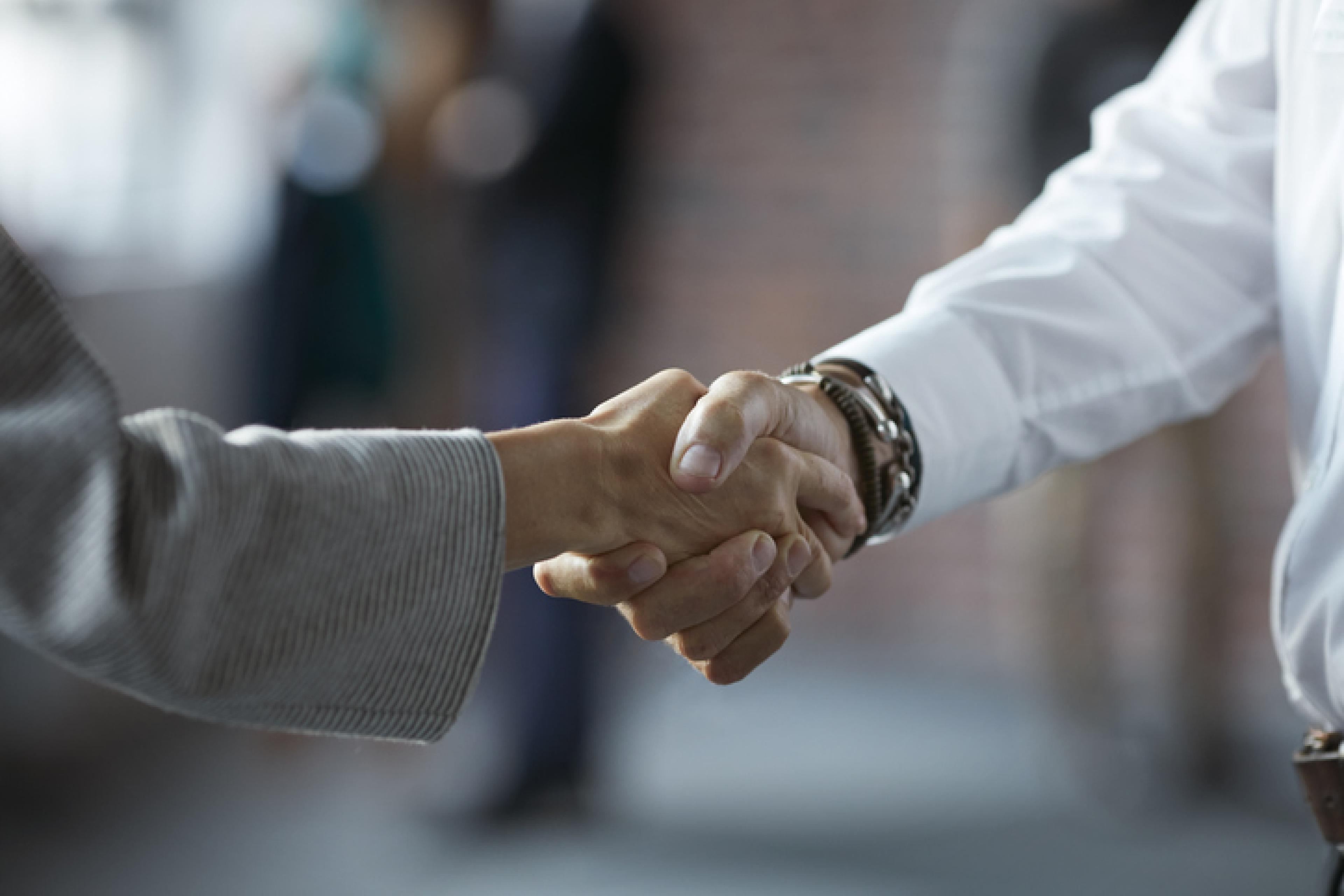 Elderly people shaking hands